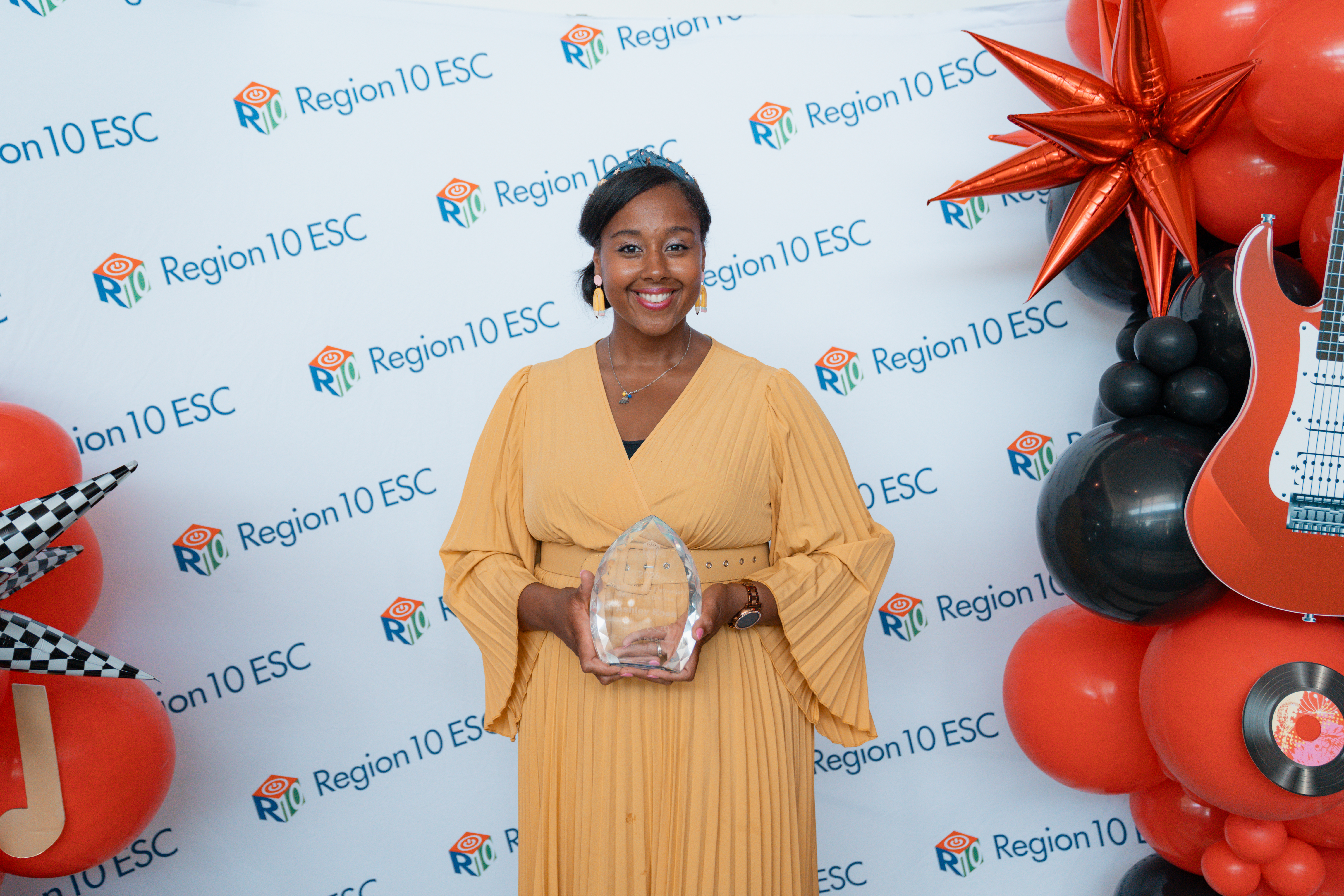 Ashley Ross stands with her award