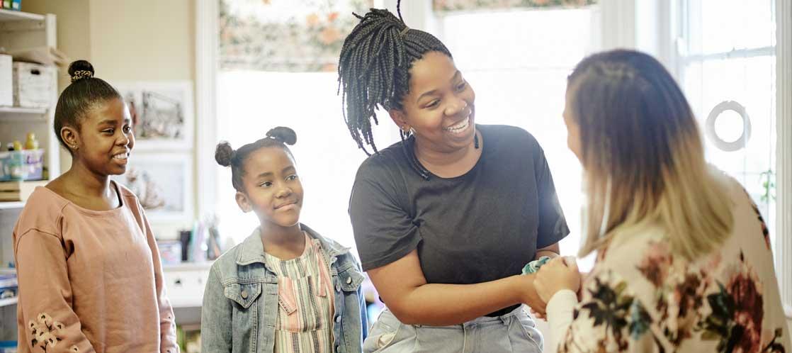 Parent, teacher and students meeting in classroom
