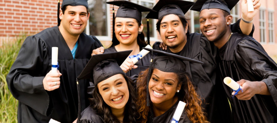 Multi-ethnic friends excitedly hold diplomas