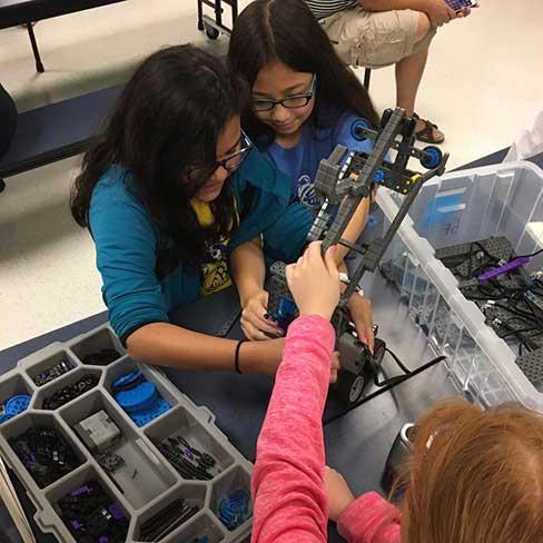 Girls working with equipment in robotics practice at Kimberlin