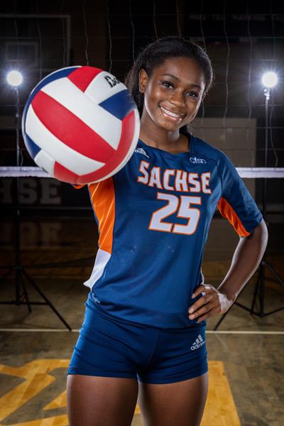 Former SHS student Zoria Heard posing with a volleyball in her hand and in Sachse HS athletic wear.