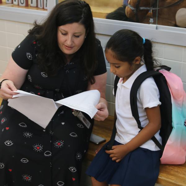 A teacher helping a student