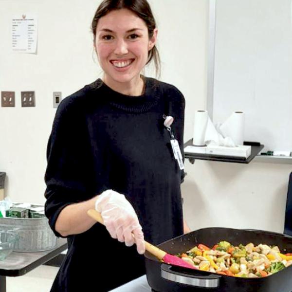 A GISD Wellness staff member demoing cooking healthy meals