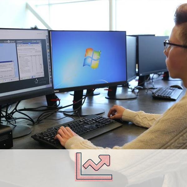 A student working on a computer. A stocks icon representing the business cluster is overlaid on the image.