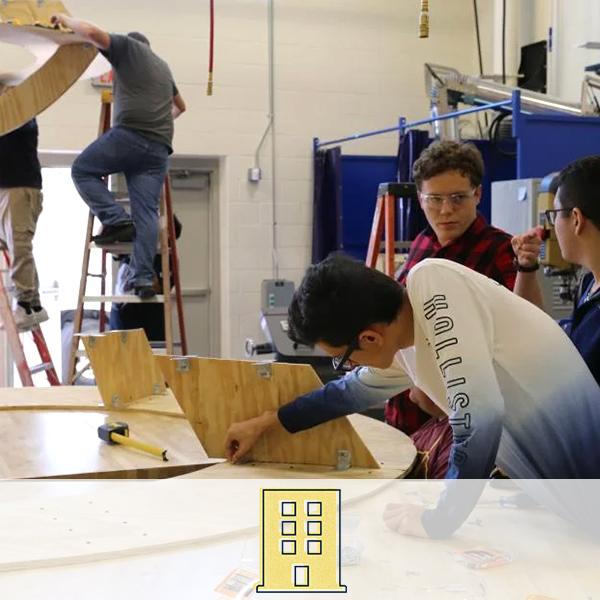 Students working as carpenters on a project. A building icon representing the architecture cluster is overlaid on the image.