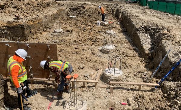 Two construction workers working in the ground