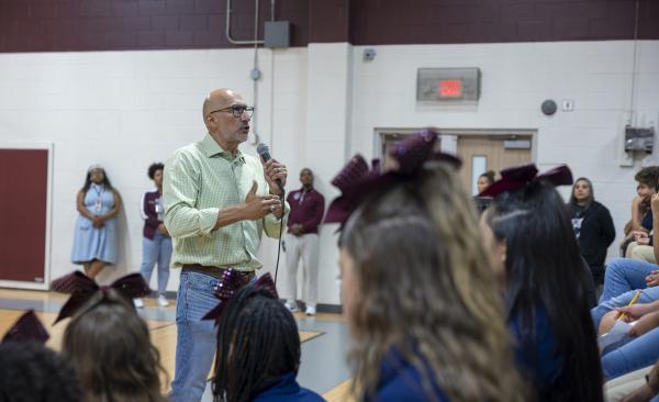 Dr. Lopez addresses a large group of students