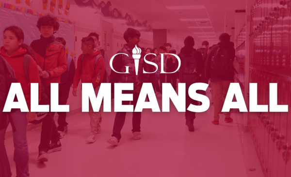 Text reading "All means all" on top of a picture of students walking in a hallway