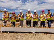 Board with hard hats and helmets ready for the ceremonial groundbreaking for  Sachse High School Multi-program Activity Center