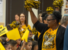 Teacher with young students a pep rally