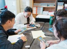 Students using calculators in study group.