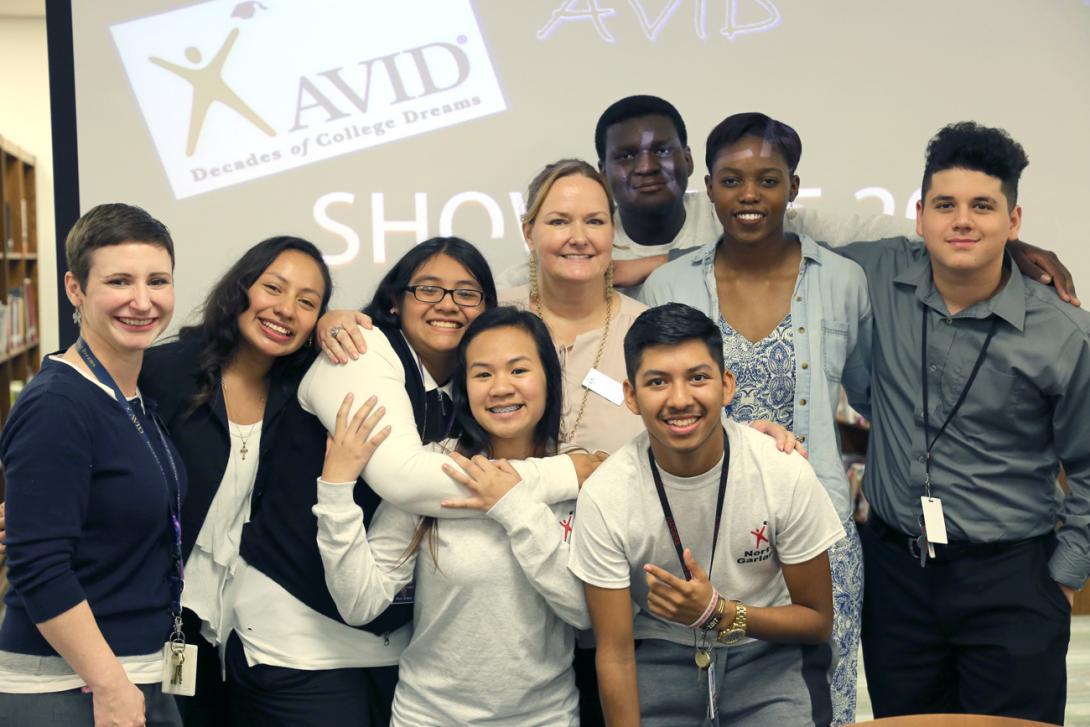 AVID students and teachers smiling at the AVID showcase