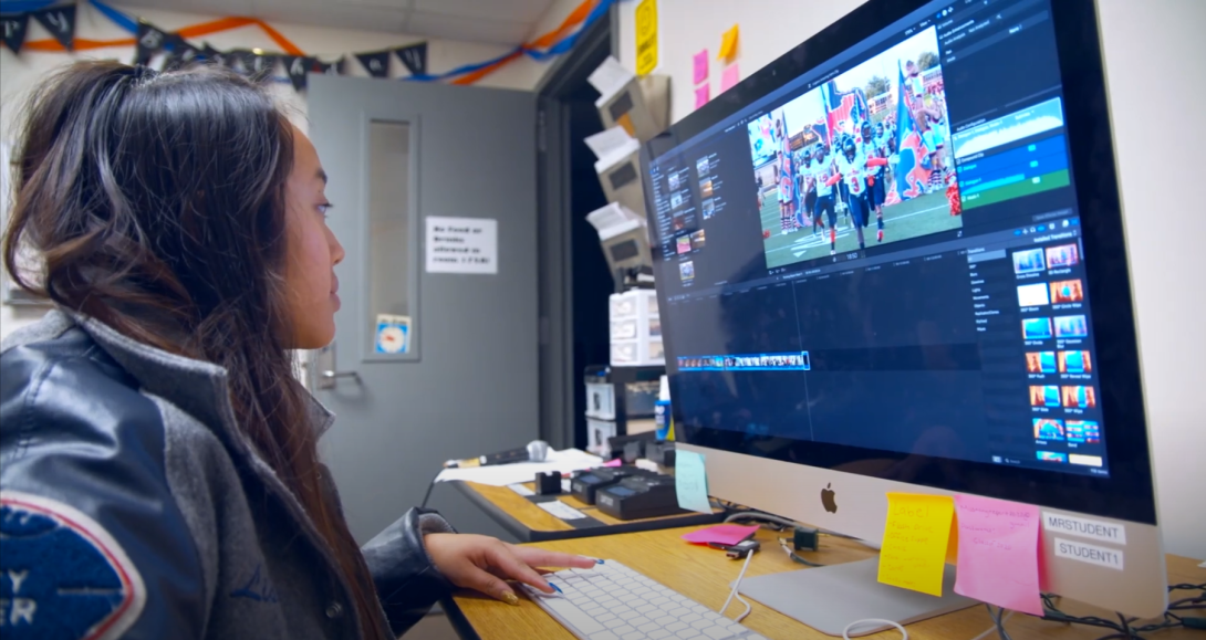 Student working on computer video upload