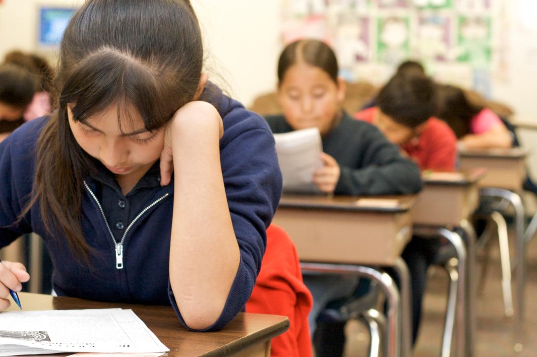 A student working on an exam in class