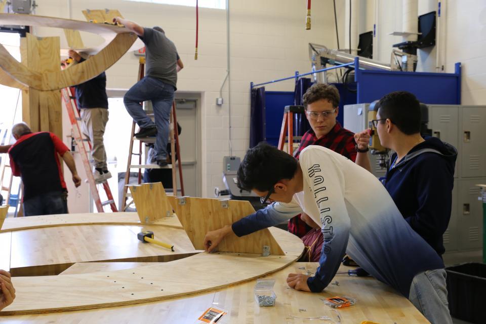 Students working as carpenters on a project