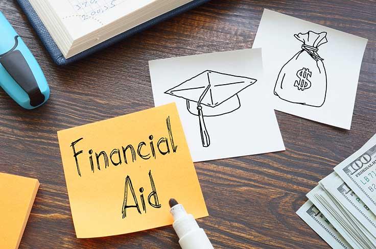 Sticky notes on a desk. One showing Financial Aid, another with sketch of graduation cap and the third with sketch of a money bag.