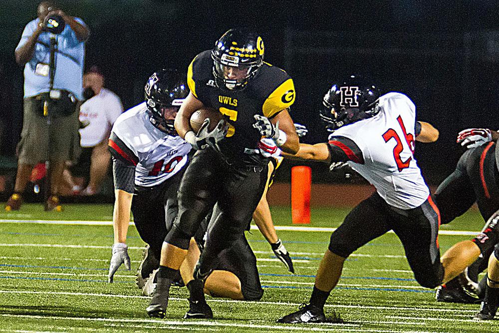 Football players wresting for a ball