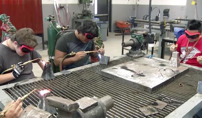 Students welding metal