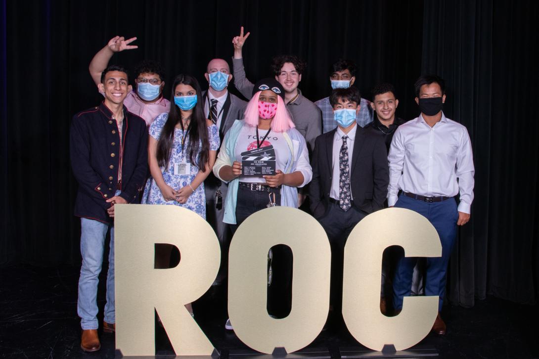 Film students posing with ROC sign