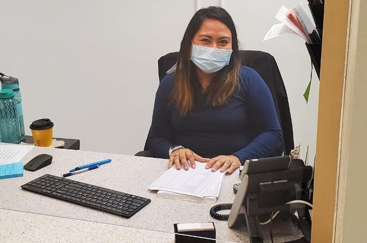 Employee working at desk in Enrollment Center Clinic