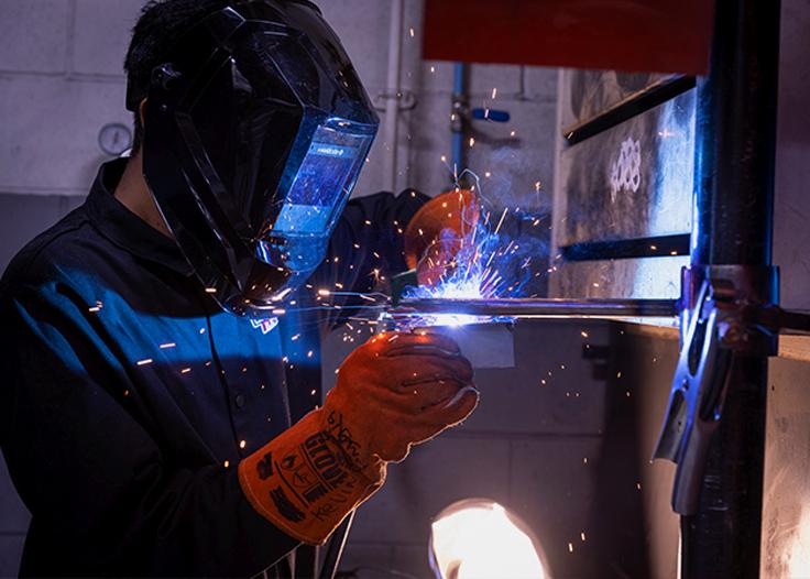 A student working on soldering equipment