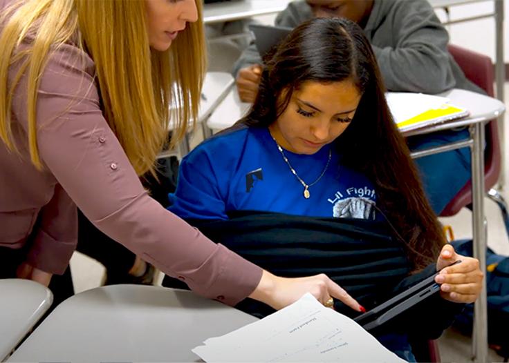 A teacher helping a student