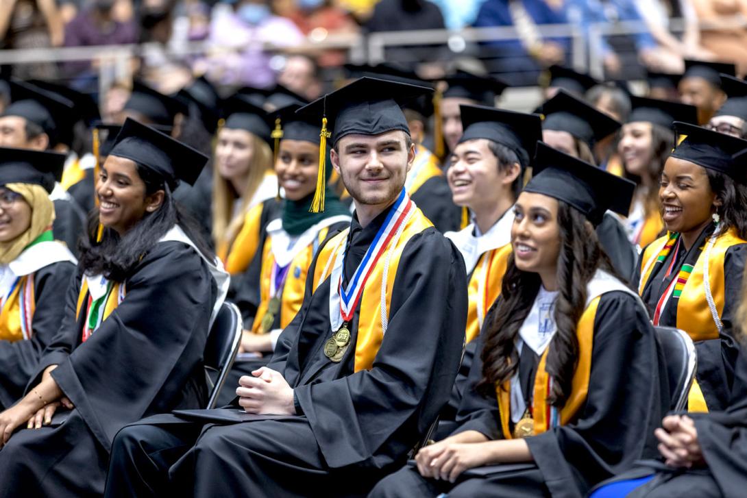 Students laughing and smiling during their graduation ceremony