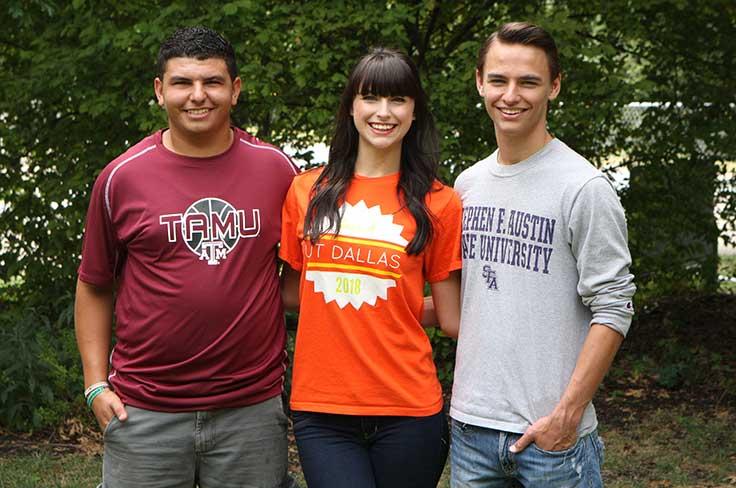 Three high school students wearing college shirts.