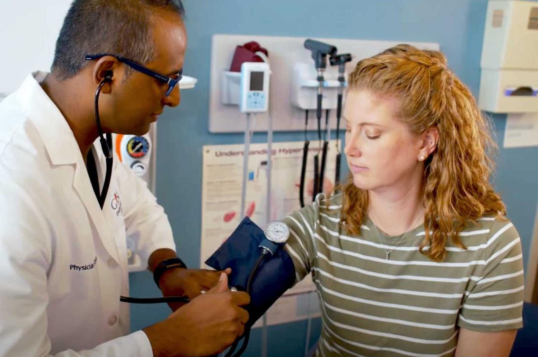 An employee getting her blood pressure checked at the Employee Clinic