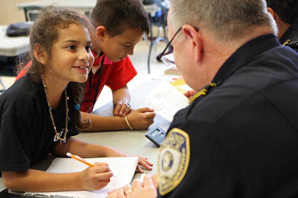 Students interacting with a School Resource Officer