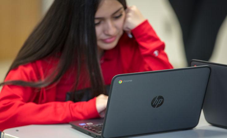 A student working on her Chromebook