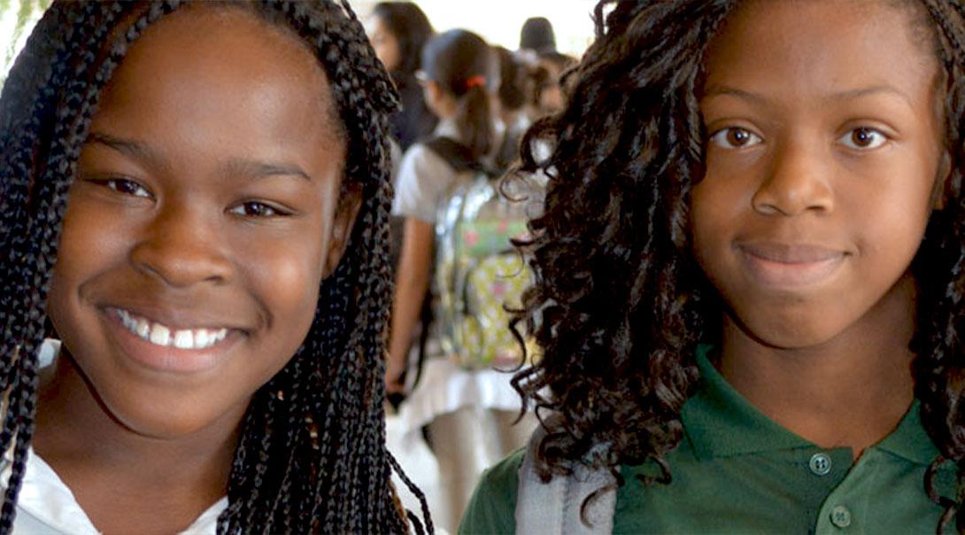 Two African American student smiling