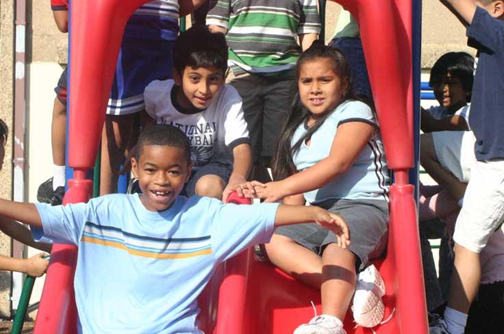 Students together on playground equipment