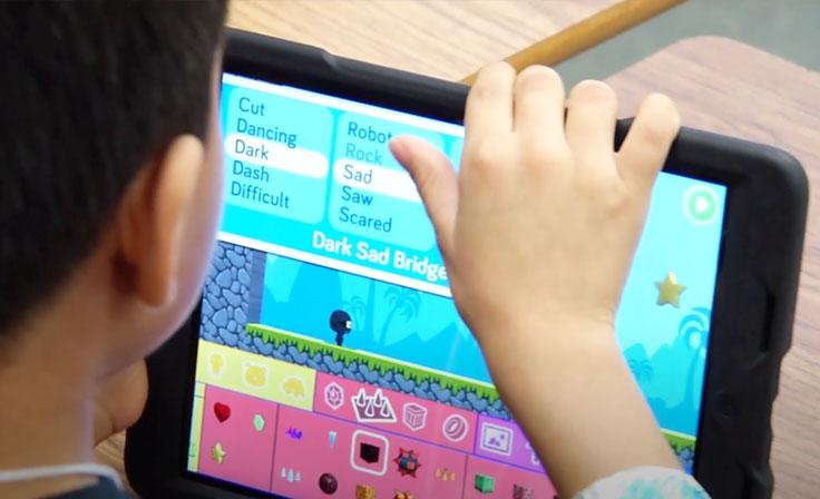 A young student using an iPad for a word game lesson