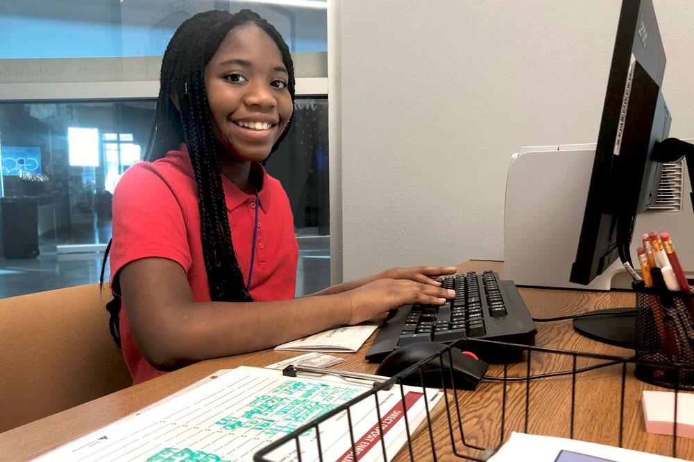 A girl working on the computer for the JA BizTown program at the GRCTC