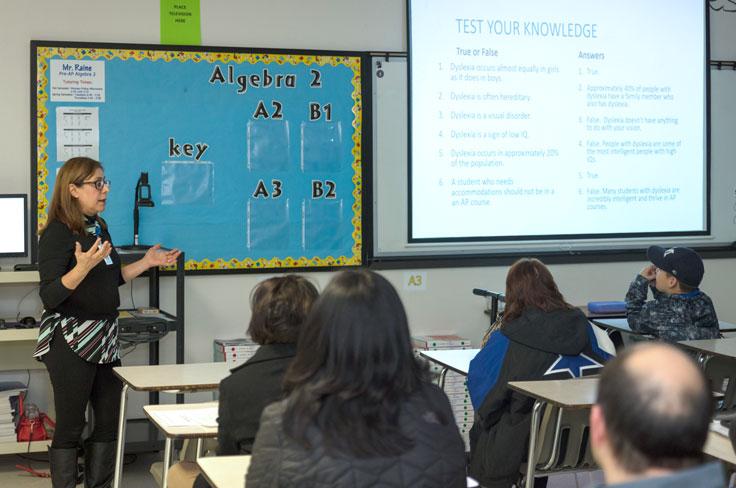An instructor teaching adults and students about dyslexia.