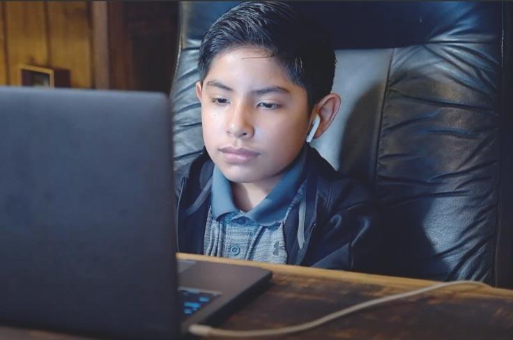 A student using their computer at home.