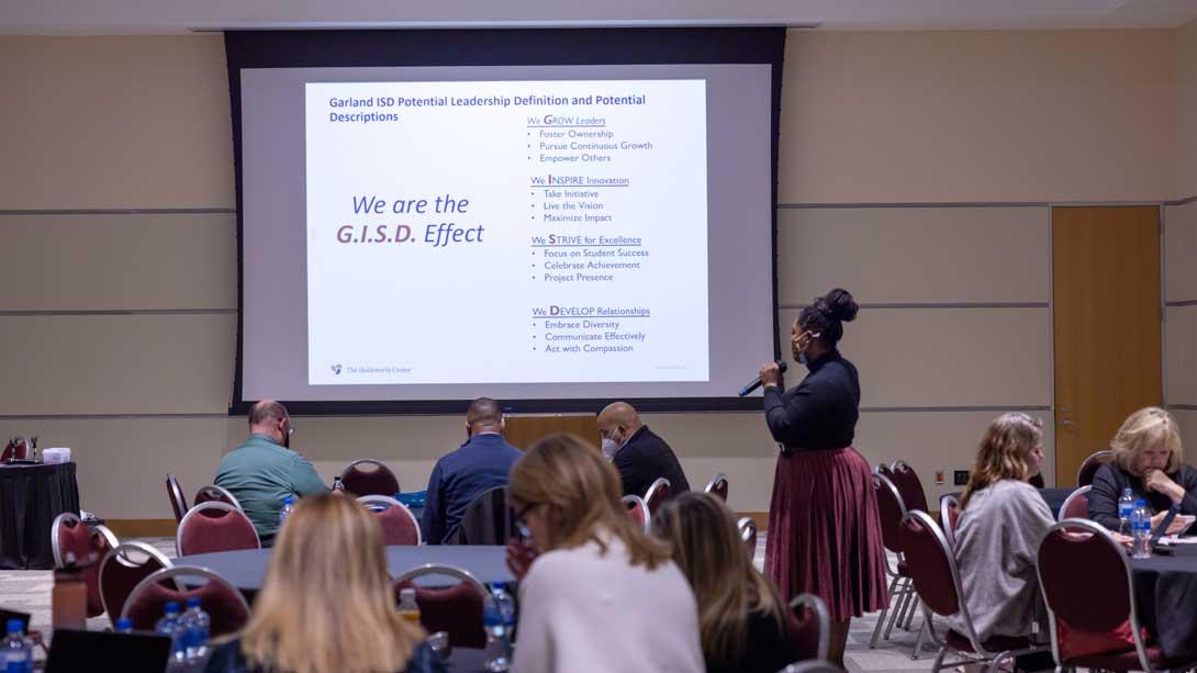 Participants in Leadership Meeting with facilitator reviewing the potential leadership definition.