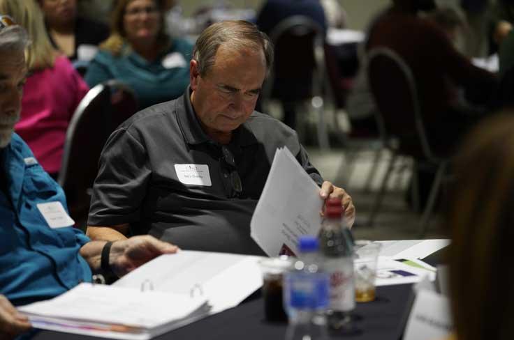 Member of Bond Steering Committee reviewing materials