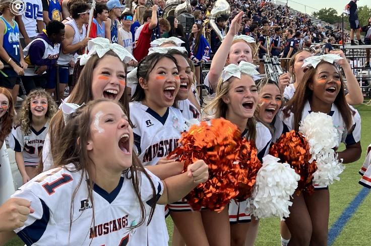 Sachse HS cheerleaders on the sideline at a football game