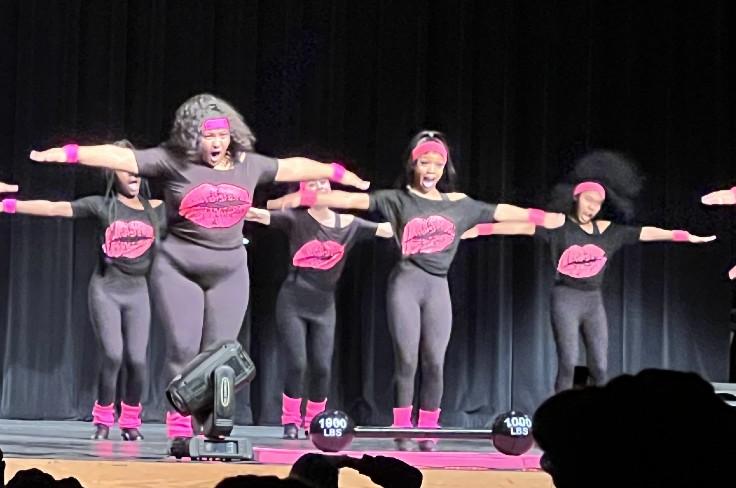 a group of kids in a STEP performance on stage