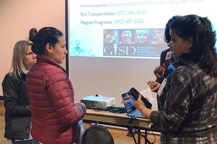 GISD translator helps a parent at a school meeting