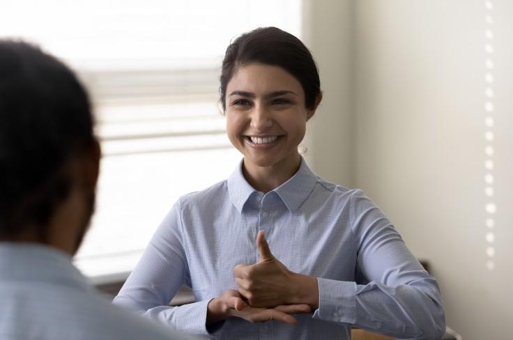 Young woman using sign language