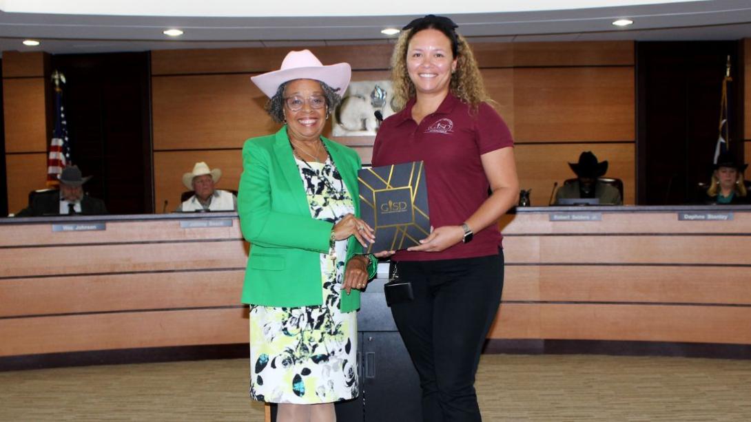 Cadeal Lacen with Board President Linda Griffin accepting her GEM award in the GISD board room