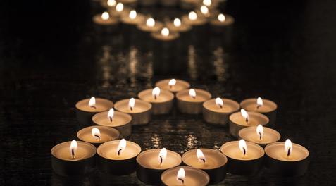 Lit candles arranged in the shape of the Star of David.