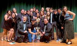 The actors of the Anatomy of Grey posing with their directors and a trophy.