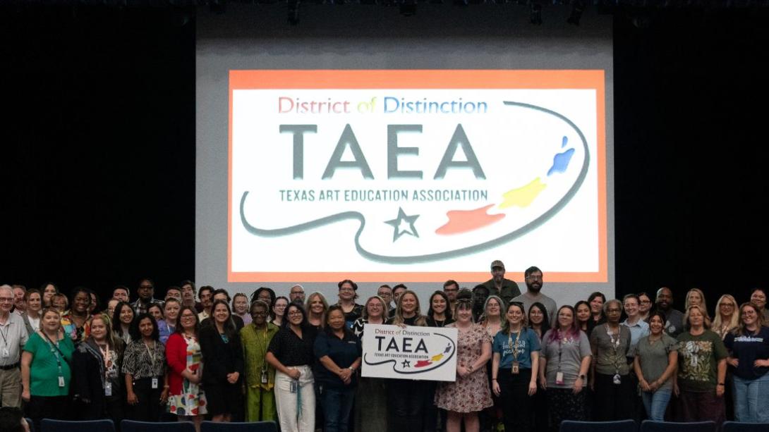 GISD art educators stand in front of large sign