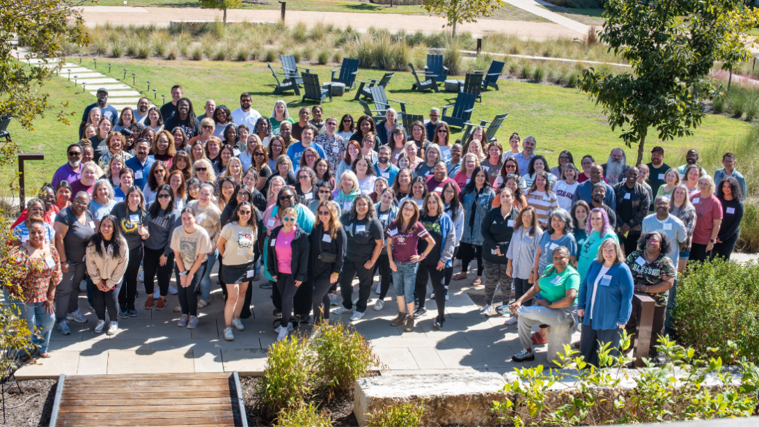 A large group of teachers standing together outdoors