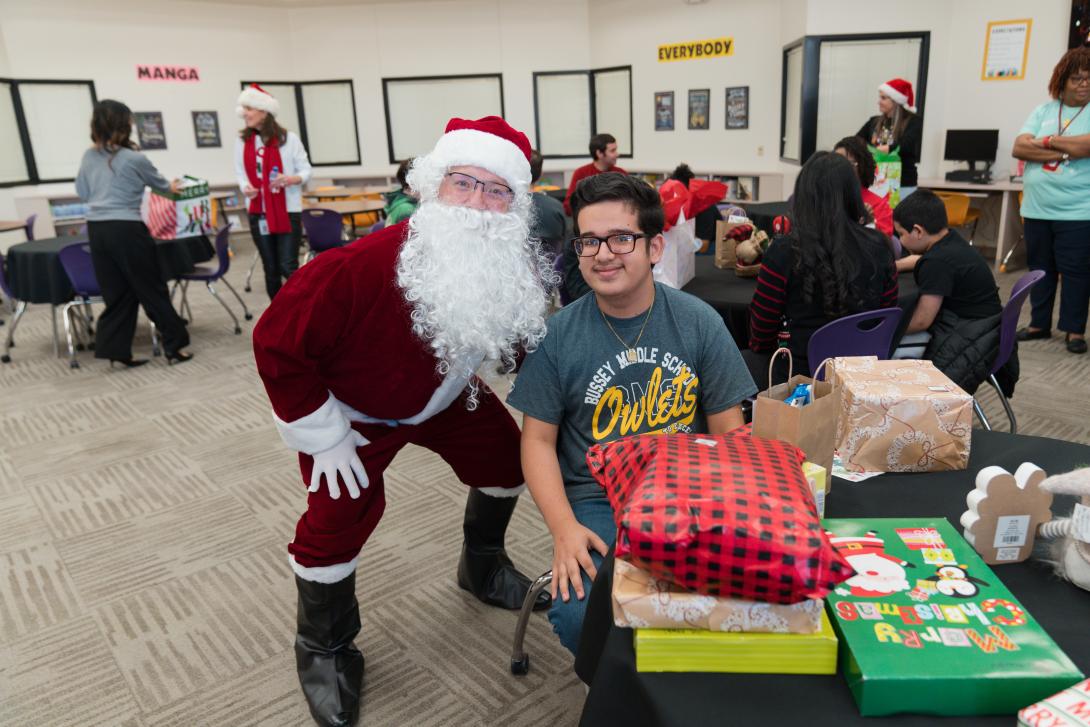 Santa poses with seated student