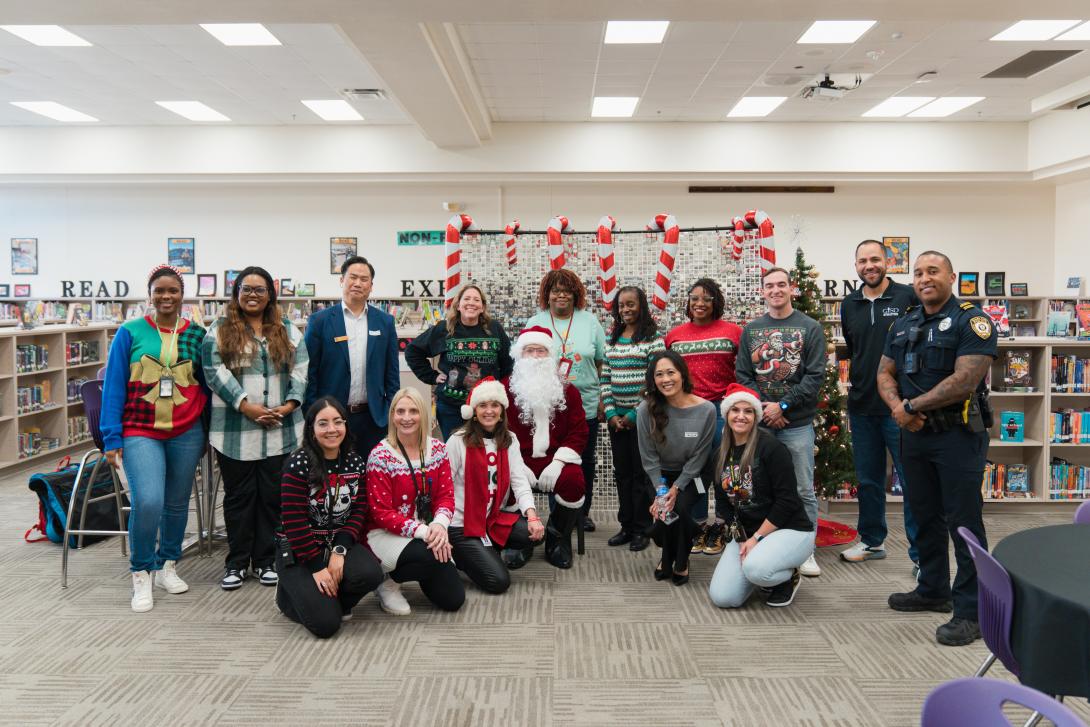 adults pose with santa